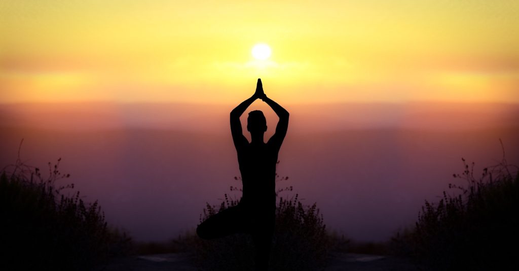 Sunrise yoga silhouette symbolizing body discipline and South Asian wellness traditions